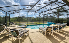 South-facing pool and spa with a lake and conservation view