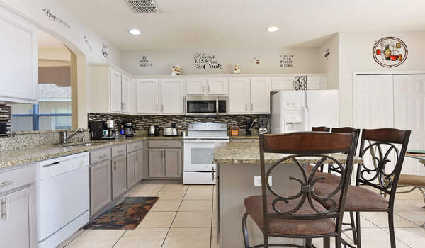 Spacious and luxurious kitchen has granite tops