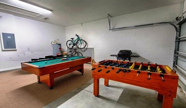 Garage has a pool table and foosball table