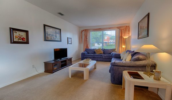 Spacious living room with comfortable furniture and 50 inch flat-screen TV
